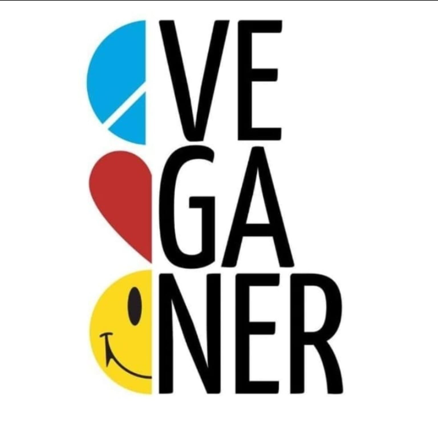 Logo for Veganer restaurant with vertical stacked bold black letters forming the word VE GANER; along the left are colorful curved shapes in blue, red, and yellow with a yellow circle showing a smiley face at the bottom.